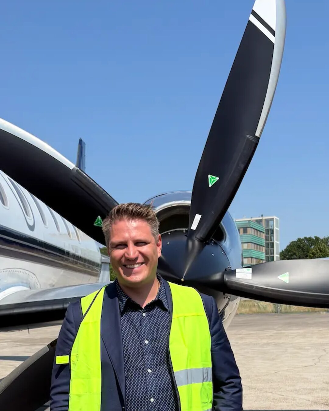Roope Kekäläinen, CEO of LYGG and a pilot with over 10 years at leading airlines, on the apron beside a regional turboprop